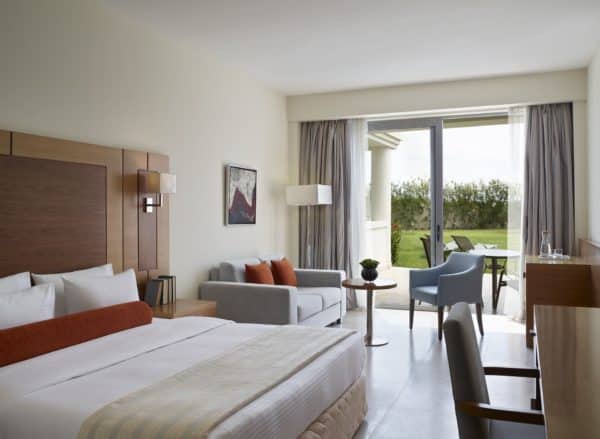 Interior view of a double room on the ground floor with garden view at Apollo Blue Hotel