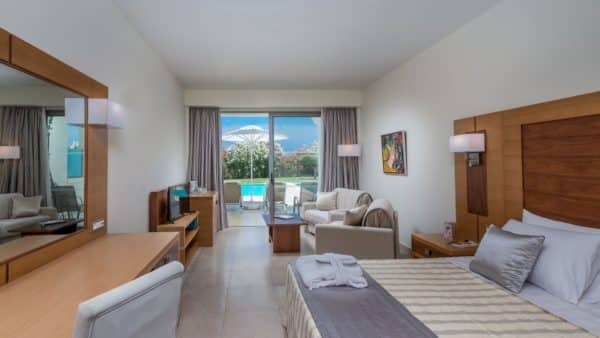 Interior view of a private pool room on the ground floor with garden view at Apollo Blue Hotel