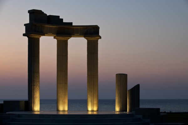 The illuminated ancient Greek replica columns of Apollo Blue Hotel