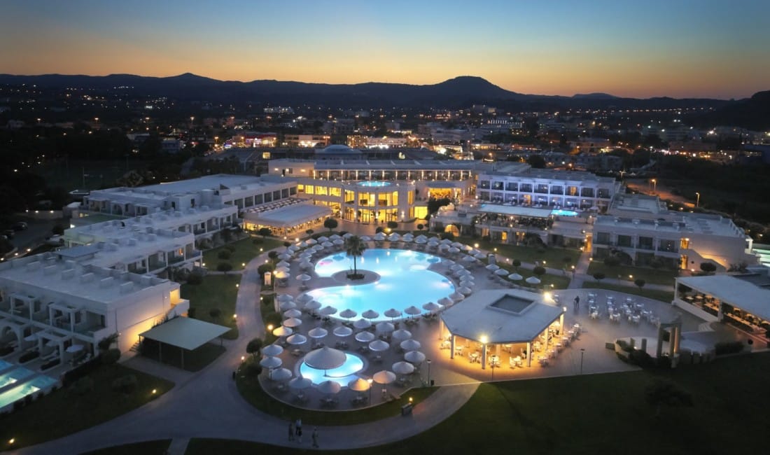 Apollo Blue Hotel from above showing all facilities with a sunset backdrop