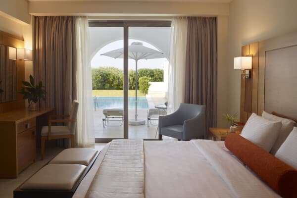 Interior view of room showing the bed and terrace with private pool at Apollo Blue Hotel