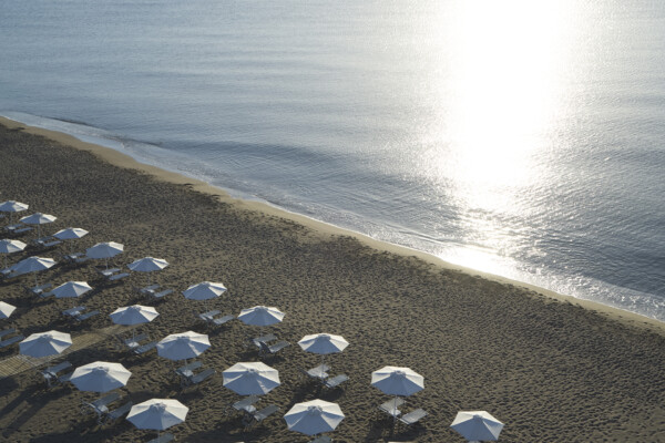 Shimmering sea and beach with sun parasols at Apollo Blue Hotel