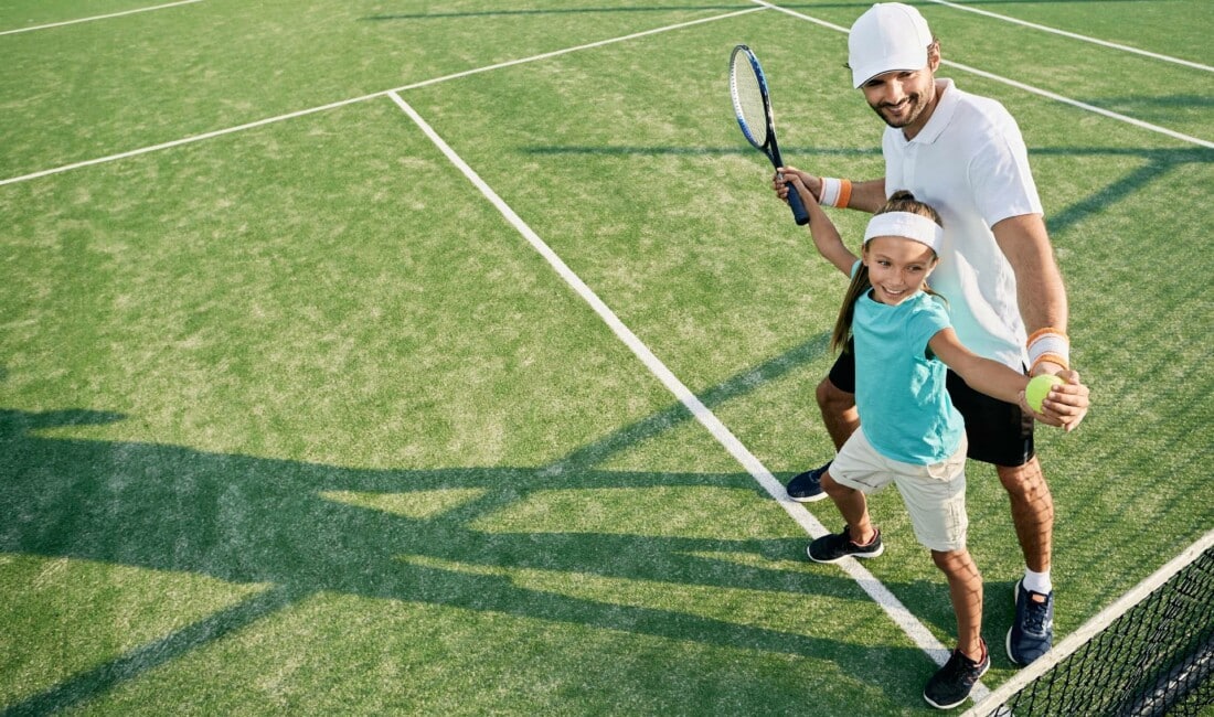 girl-playing-tennis-inside-tennis-faciities-of-rhodes-family-resort-for-families